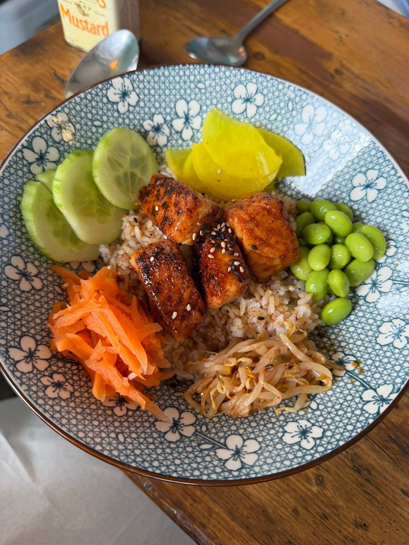 Rice bowl with glazed salmon, edamame, cucumber, carrot and pickles at Graze